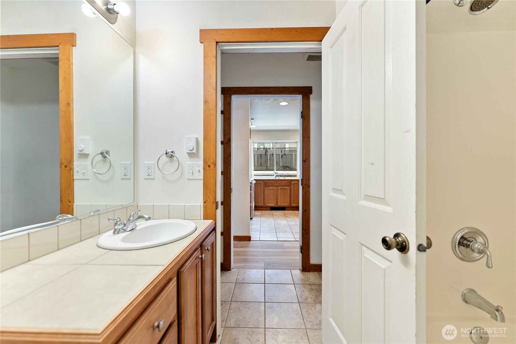 203 Washington Street Winthrop, WA 98862 - Photo 23 of 39 a bathroom with a granite countertop sink a mirror and a shower