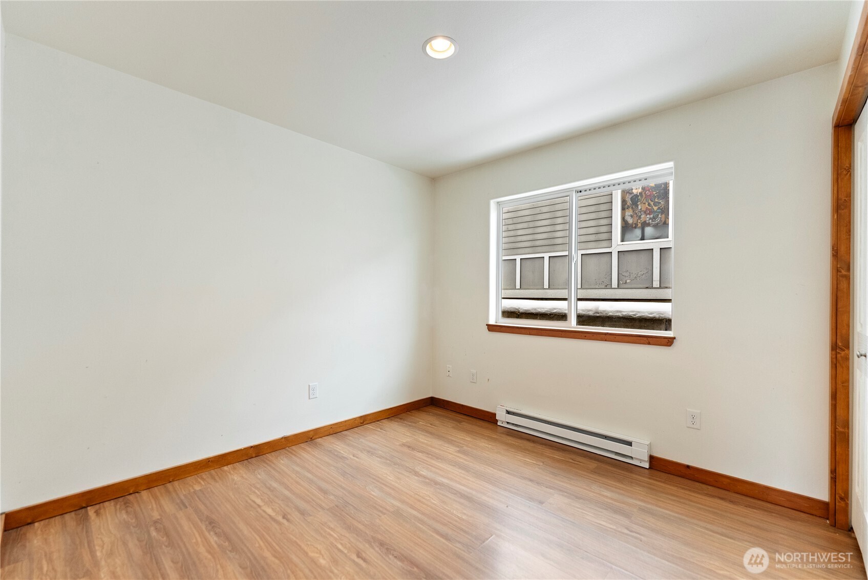 203 Washington Street Winthrop, WA 98862 - Photo 26 of 39 an empty room with wooden floor and windows
