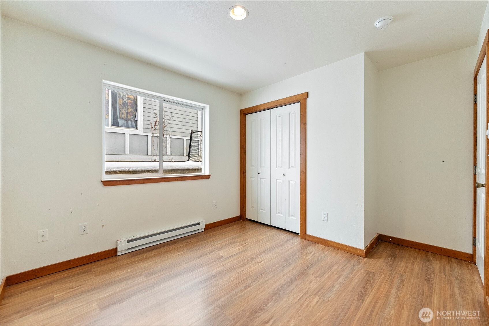 203 Washington Street Winthrop, WA 98862 - Photo 27 of 39 an empty room with wooden floor and windows