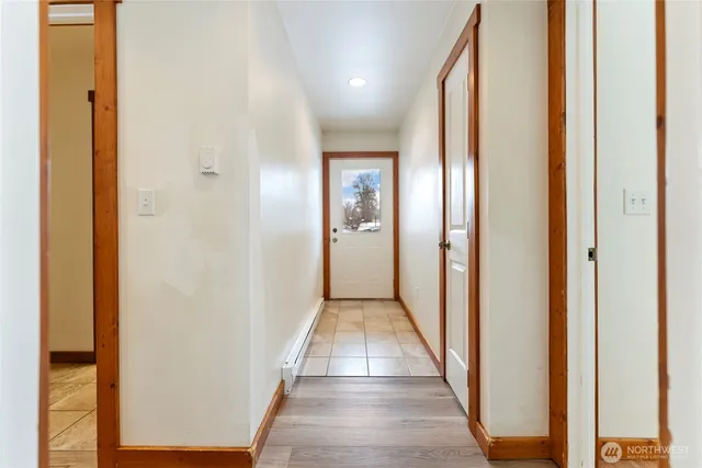 a view of a hallway with wooden floor