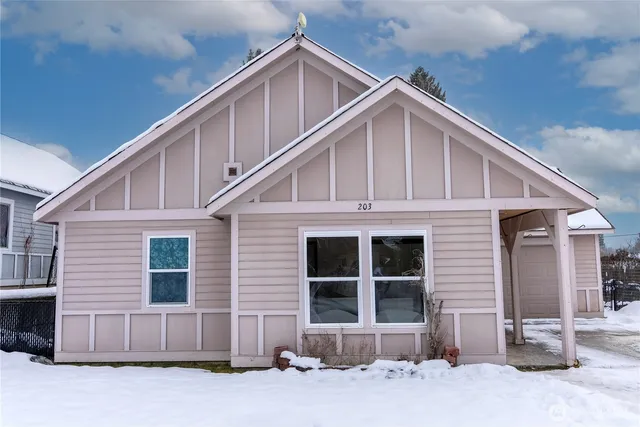 a front view of a house with a yard and parking space