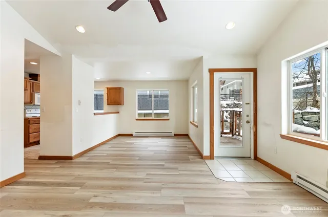 an empty room with windows and closet