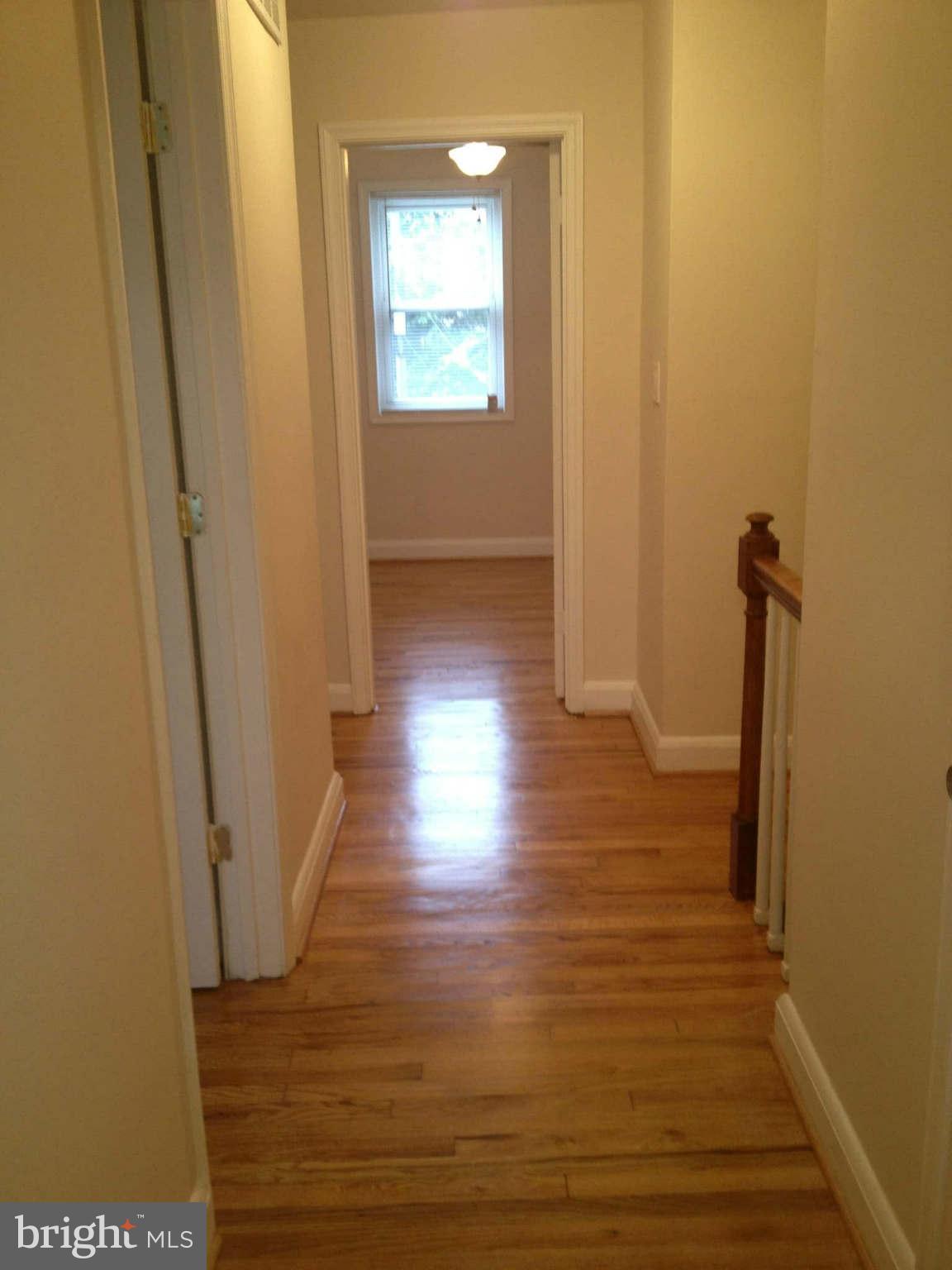 907 Masefield Road Baltimore, MD 21207 - Photo 4 of 23 a view of a hallway with wooden floor