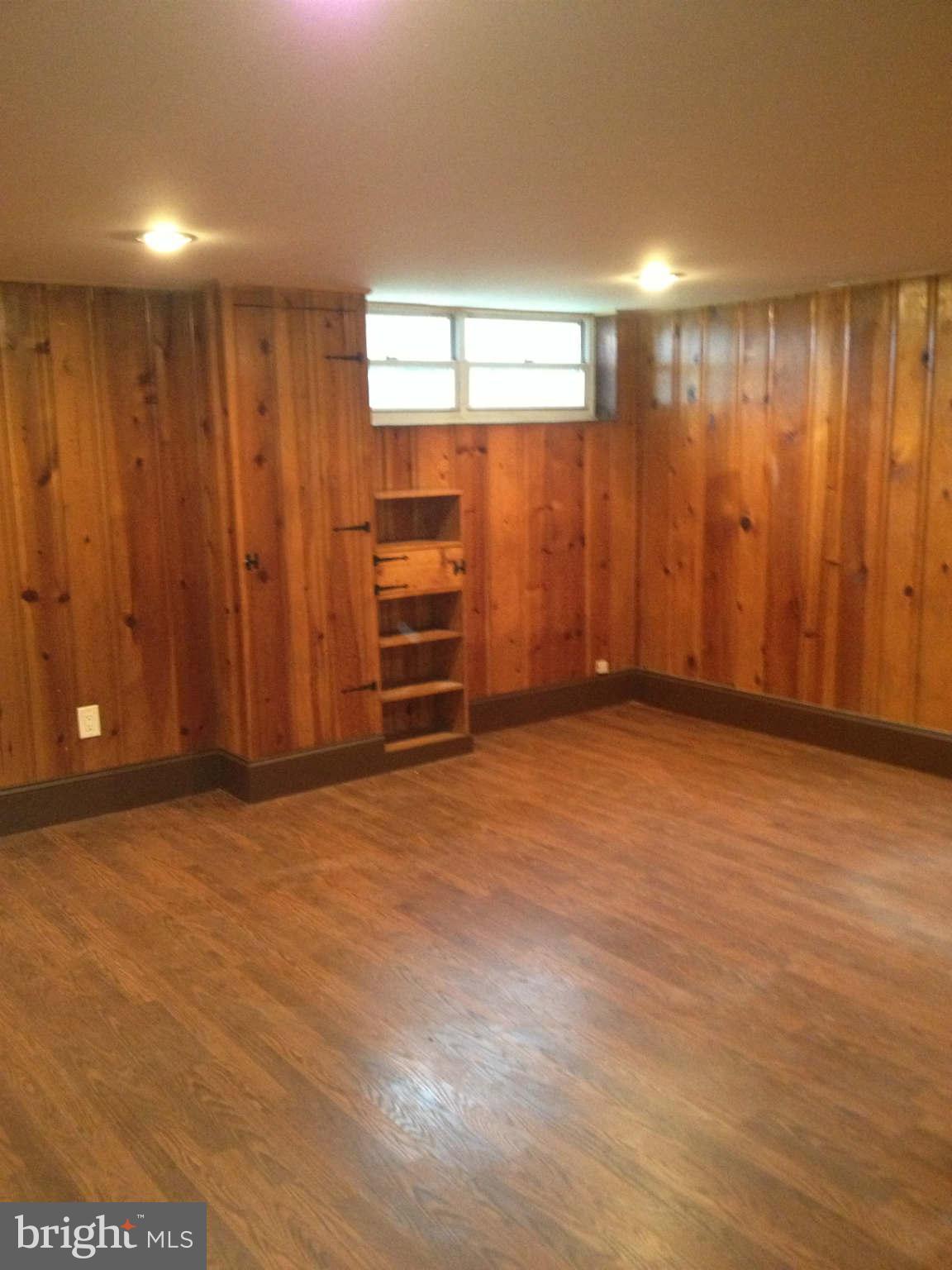 907 Masefield Road Baltimore, MD 21207 - Photo 6 of 23 an empty room with windows cabinet and door