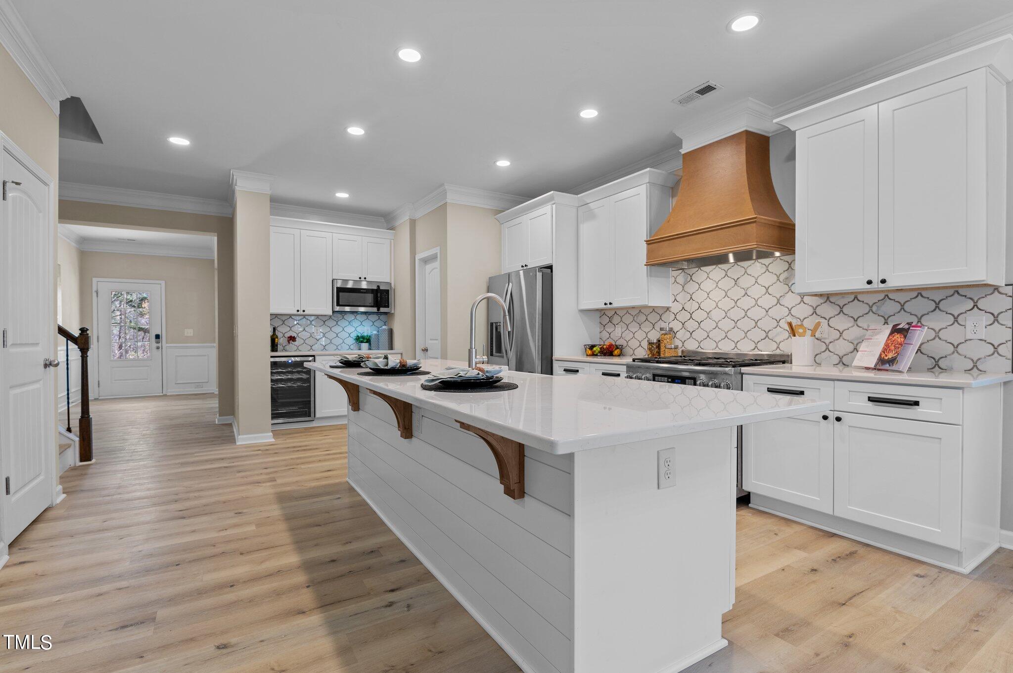 2009 Delphi Way Wake Forest, NC 27587 - Photo 13 of 40 a kitchen with white cabinets and stainless steel appliances
