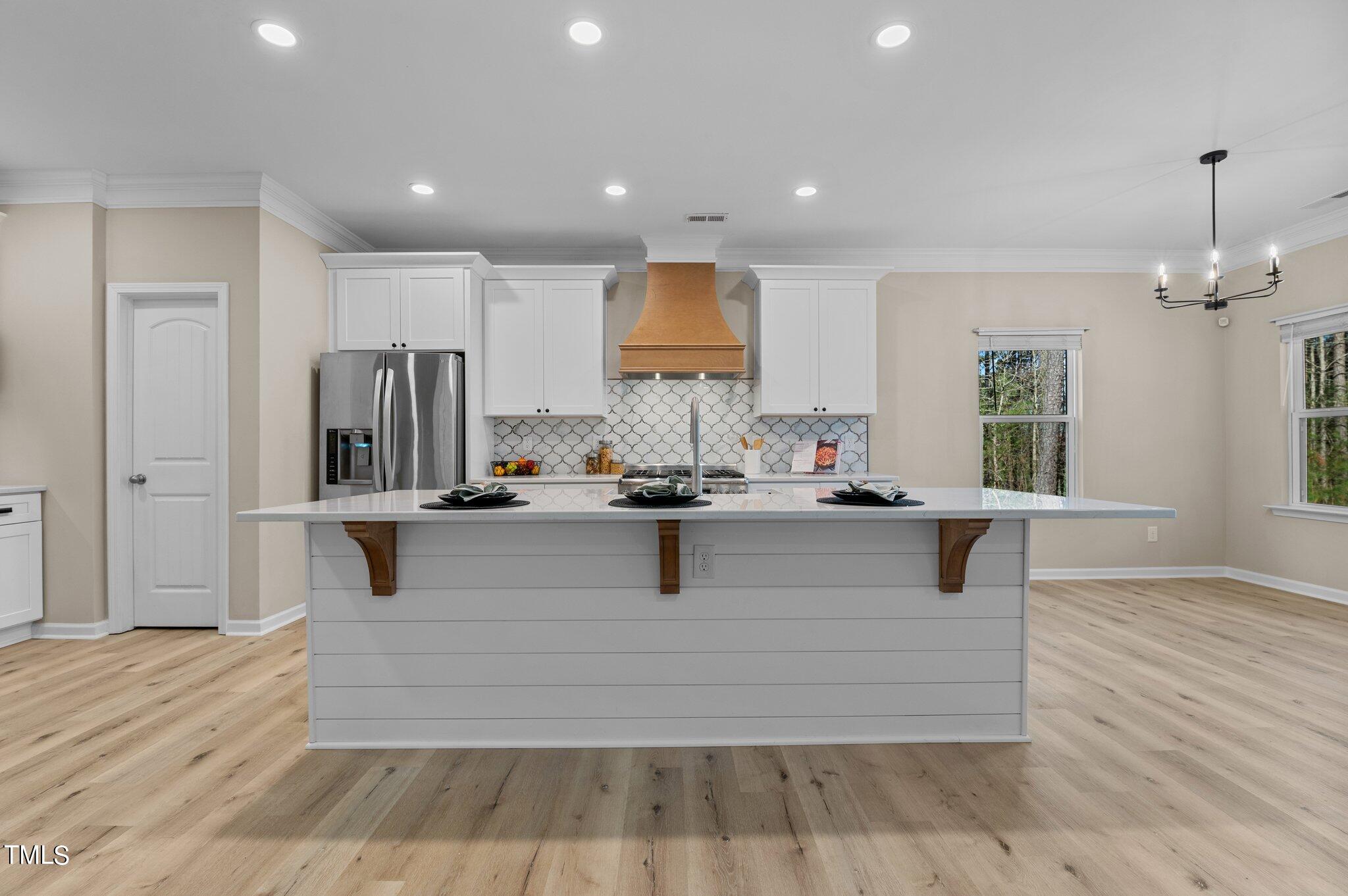 2009 Delphi Way Wake Forest, NC 27587 - Photo 14 of 40 a living room with kitchen island furniture and a wooden floor