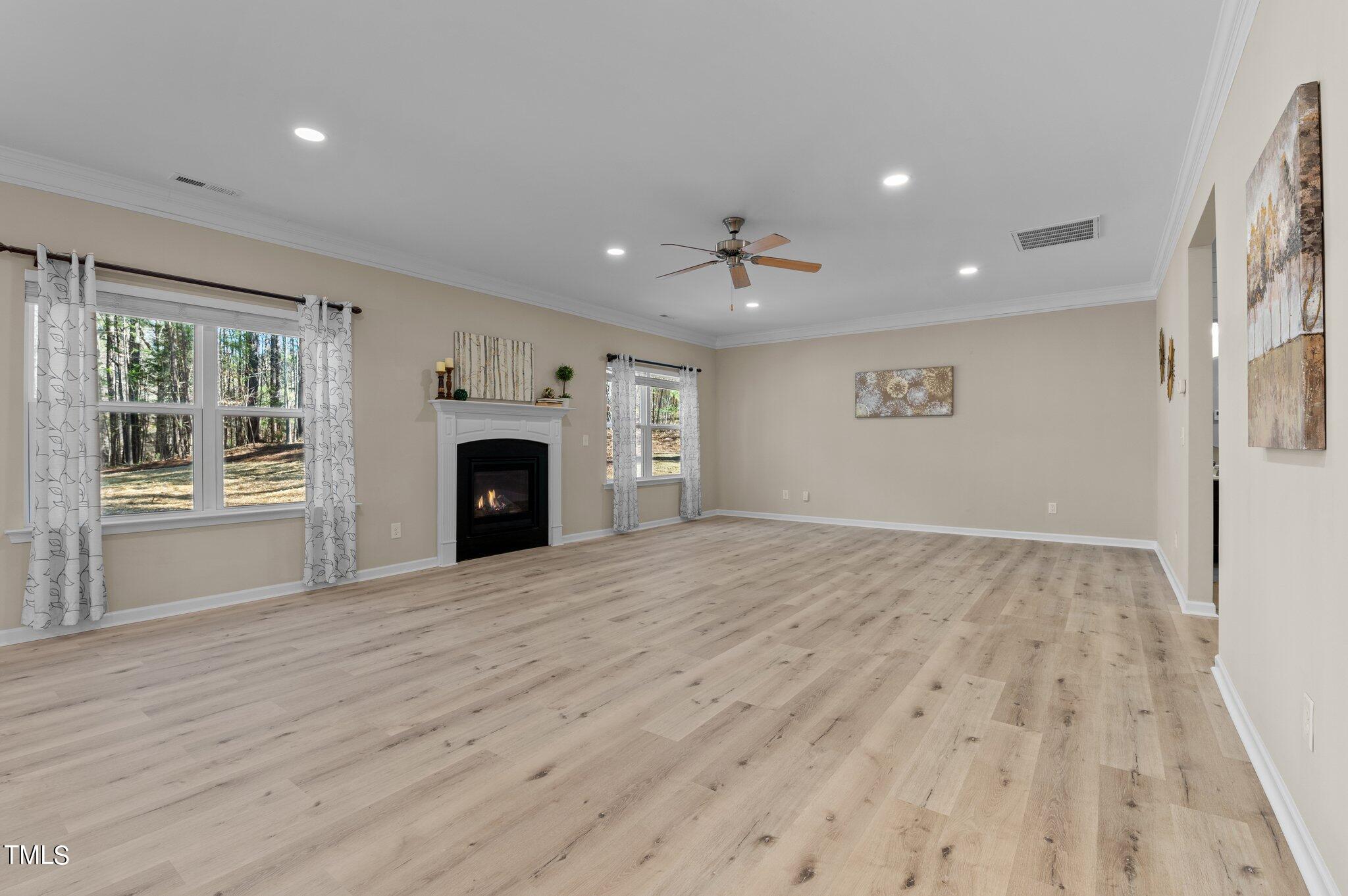 2009 Delphi Way Wake Forest, NC 27587 - Photo 16 of 40 an empty room with windows and fireplace