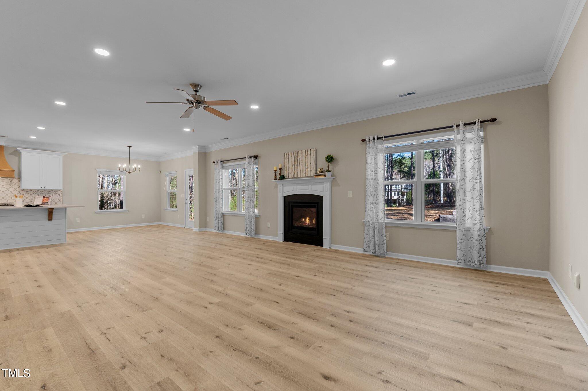 2009 Delphi Way Wake Forest, NC 27587 - Photo 17 of 40 an empty room with kitchen and fireplace