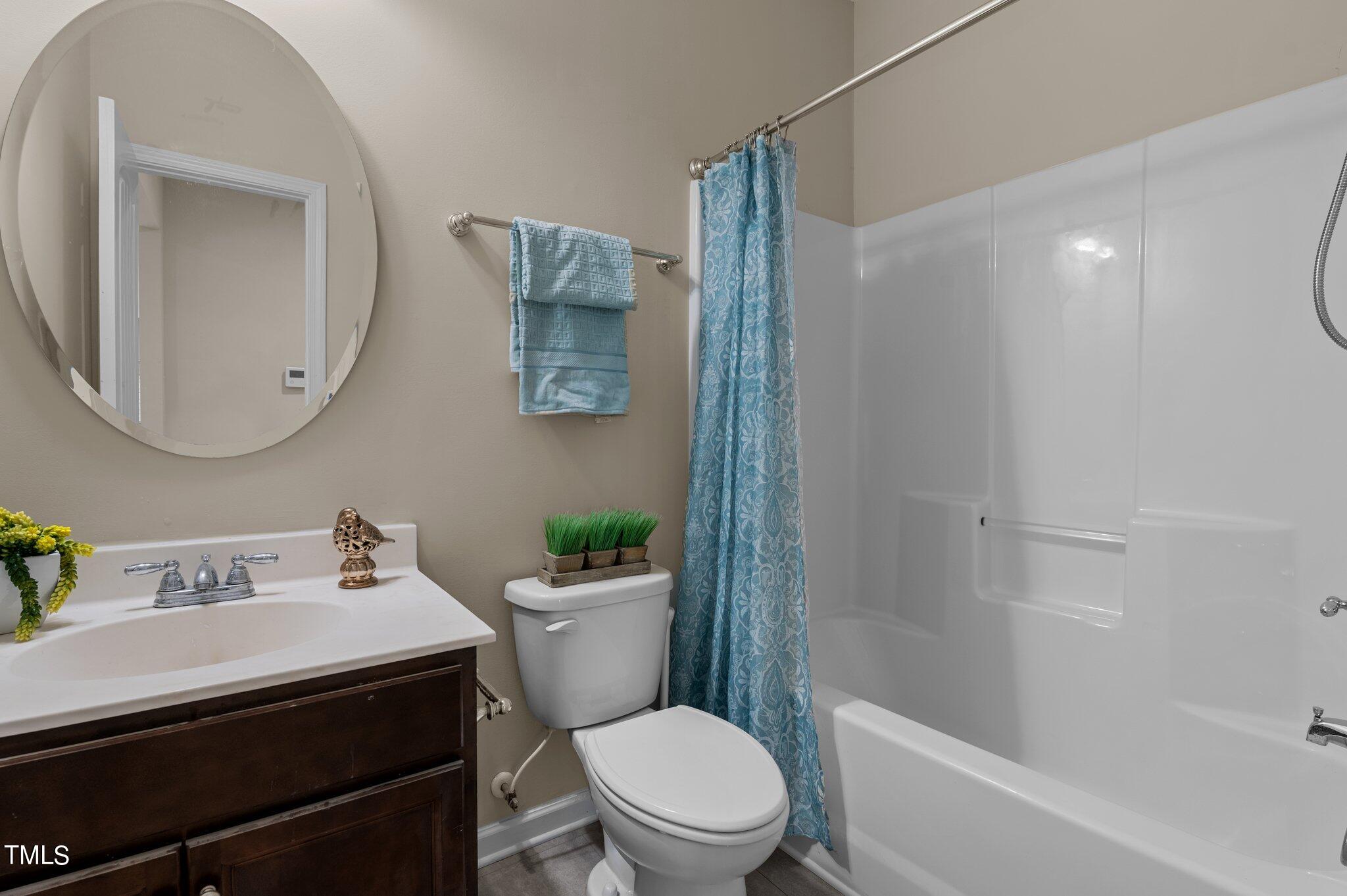 2009 Delphi Way Wake Forest, NC 27587 - Photo 19 of 40 a bathroom with a sink toilet and shower