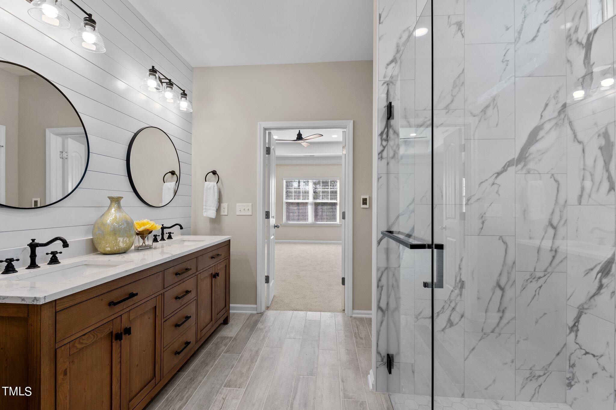 2009 Delphi Way Wake Forest, NC 27587 - Photo 25 of 40 a bathroom with a double vanity sink and a mirror