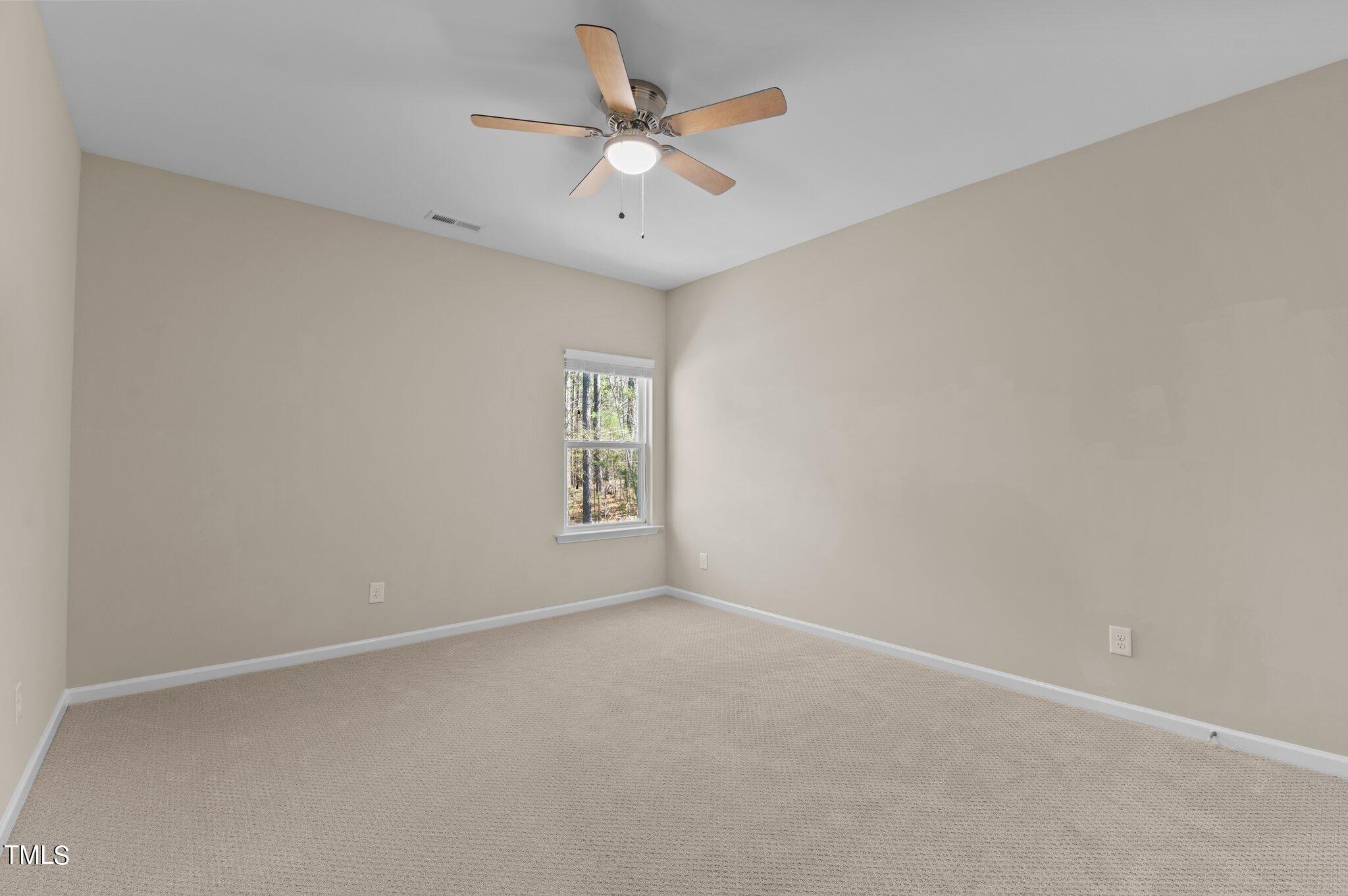 2009 Delphi Way Wake Forest, NC 27587 - Photo 30 of 40 an empty room with a window and a ceiling fan