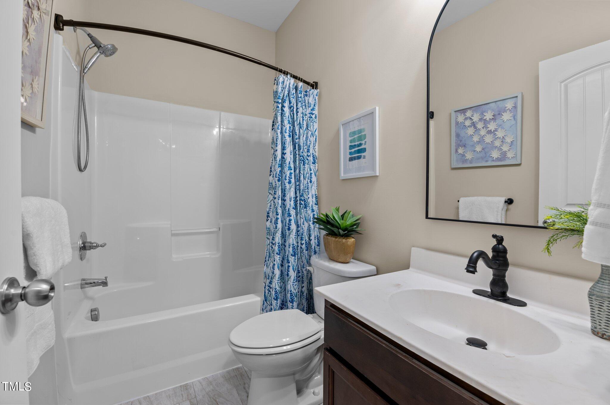 2009 Delphi Way Wake Forest, NC 27587 - Photo 31 of 40 a bathroom with a sink toilet and shower