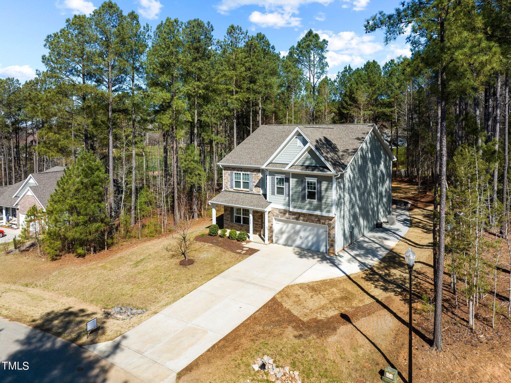 2009 Delphi Way Wake Forest, NC 27587 - Photo 38 of 40 a view of house with yard outdoor seating and covered with trees