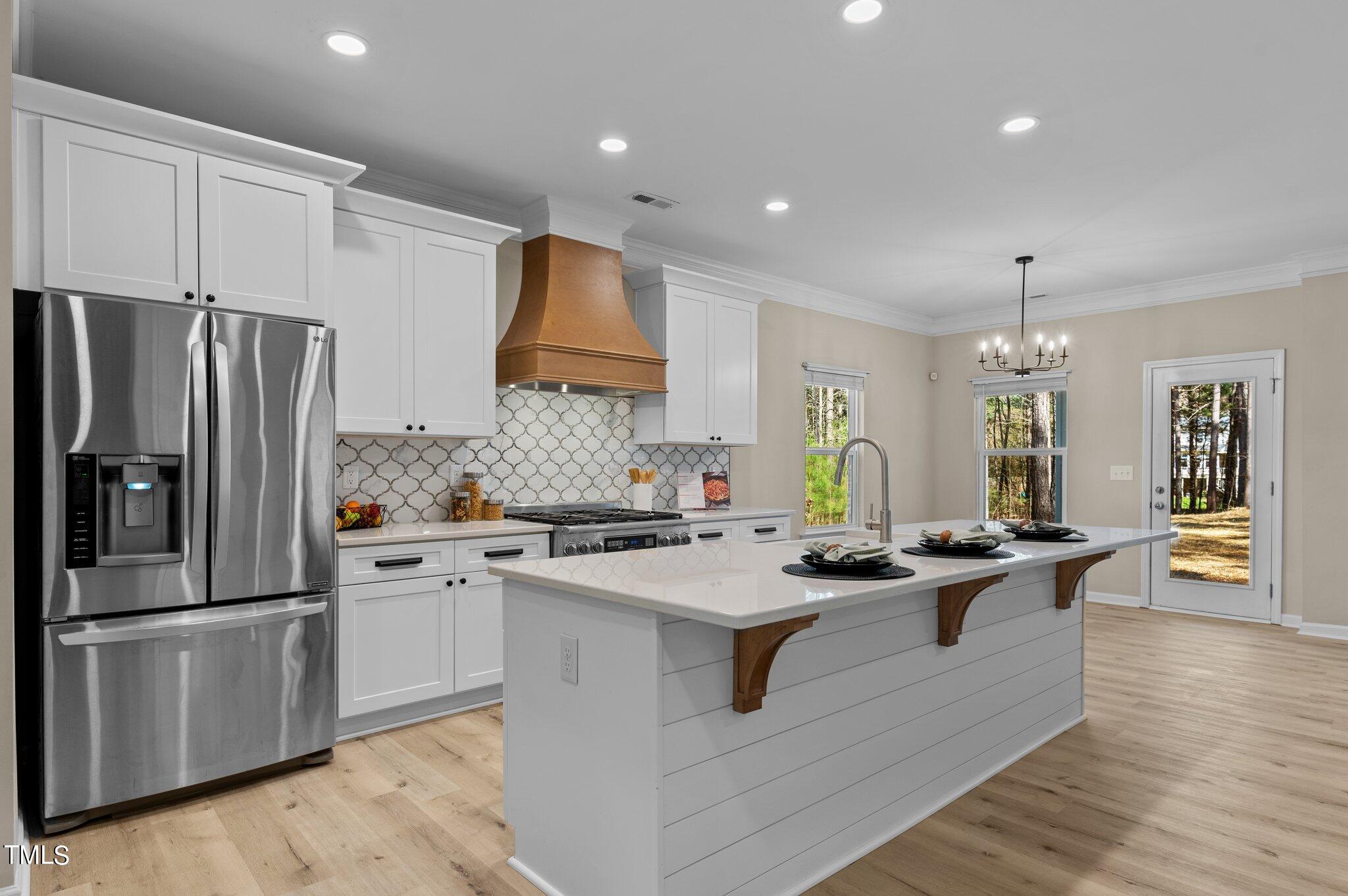 2009 Delphi Way Wake Forest, NC 27587 - Photo 8 of 40 a kitchen with stainless steel appliances granite countertop a sink stove and refrigerator