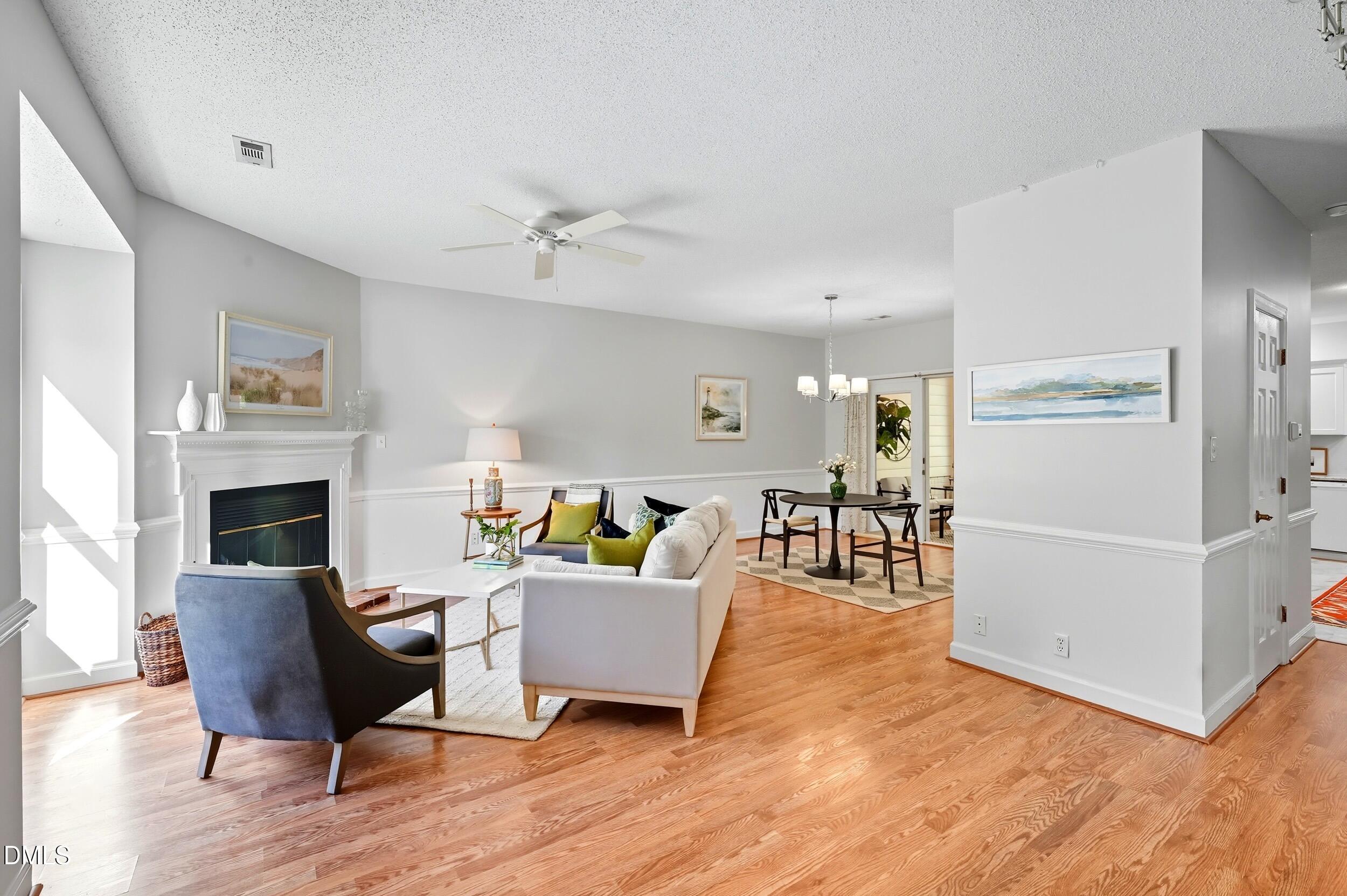 a living room with furniture a fireplace and a table