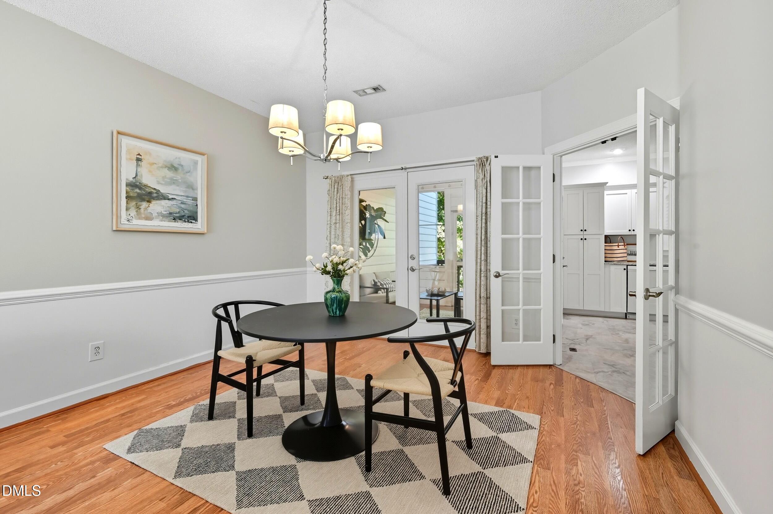 4111 Settlement Drive Durham, NC 27713 - Photo 10 of 25 a view of a dining room with furniture wooden floor and a chandelier