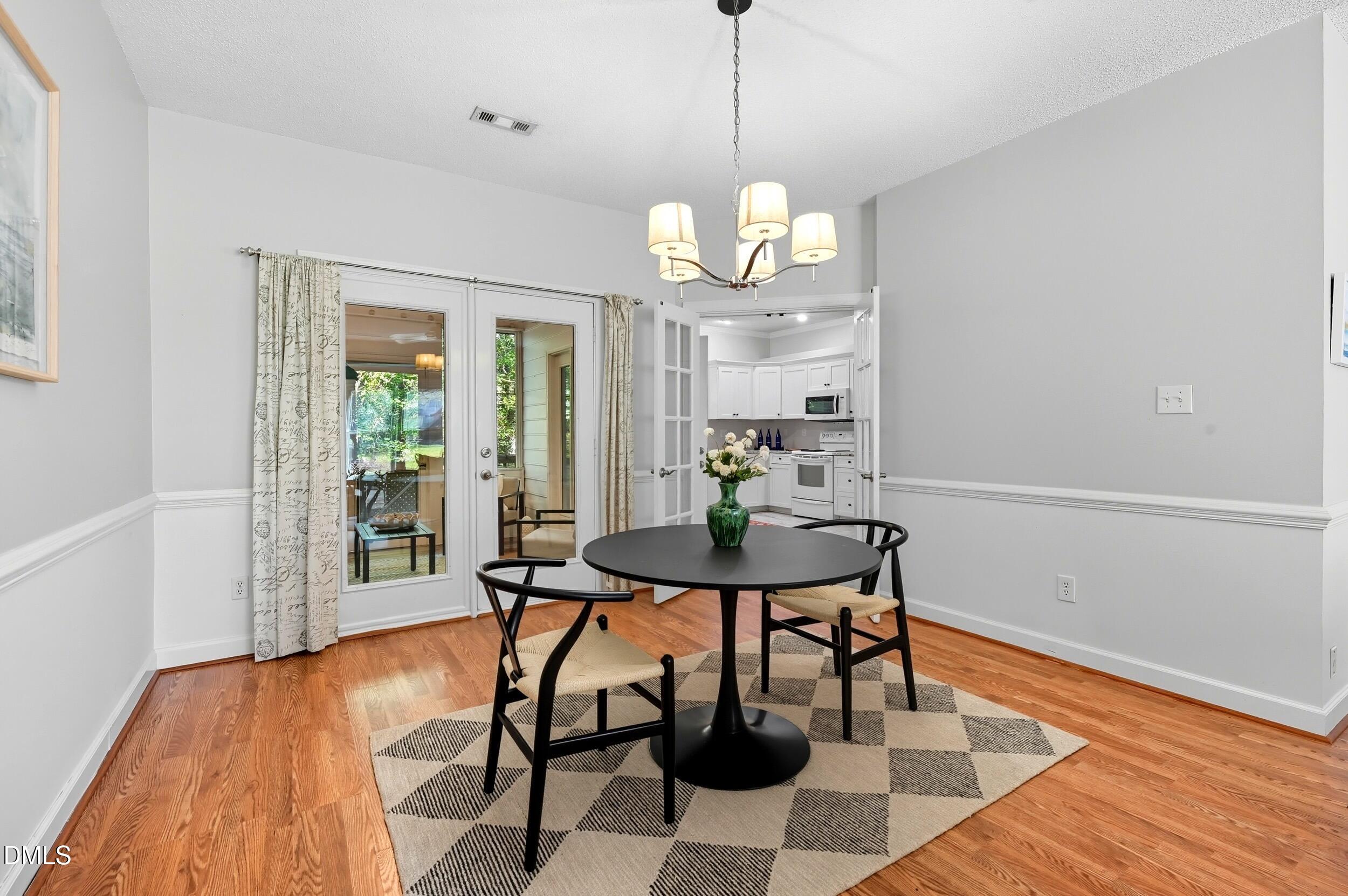 4111 Settlement Drive Durham, NC 27713 - Photo 11 of 25 a view of a dining room with furniture wooden floor and chandelier
