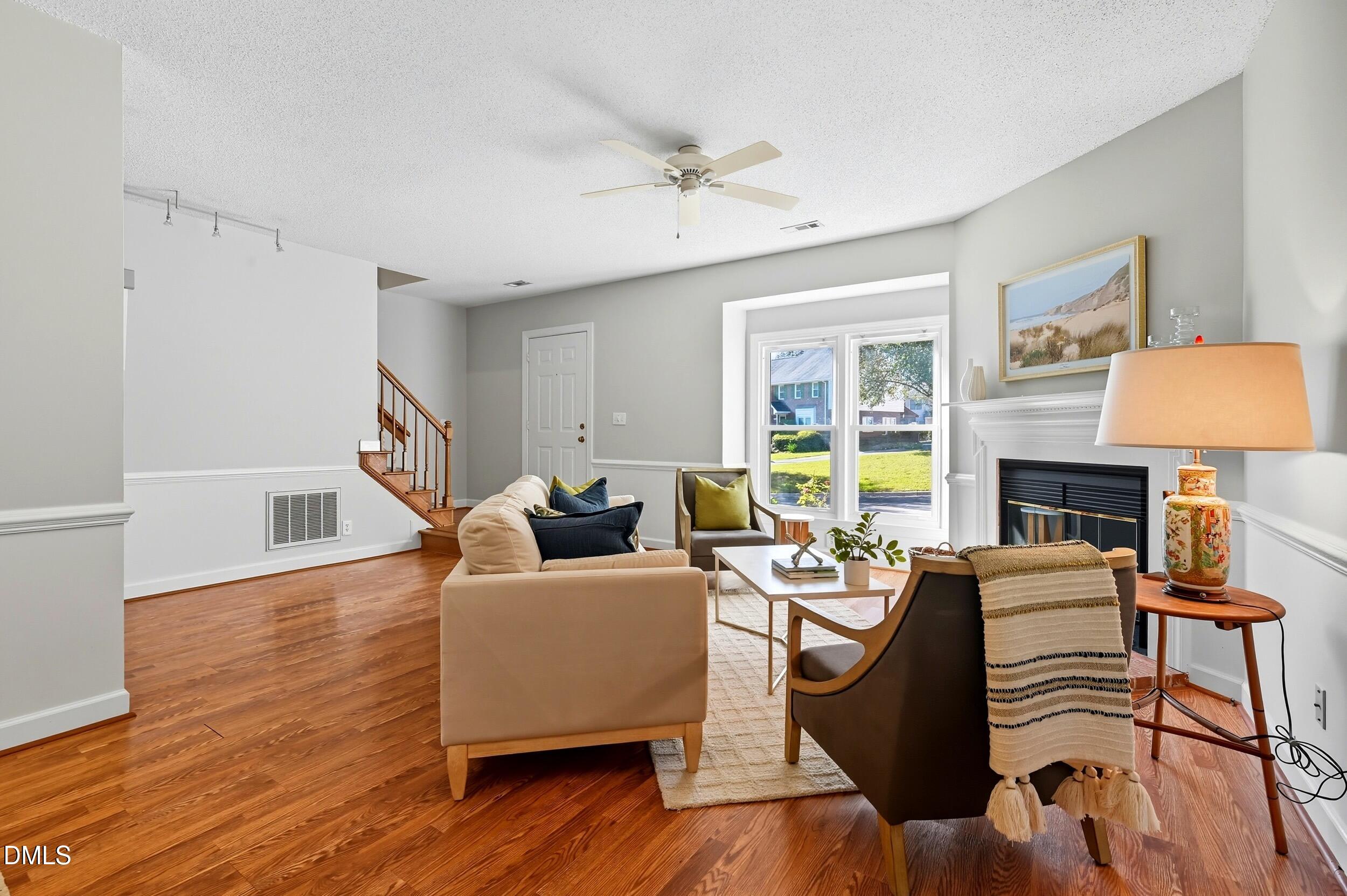 4111 Settlement Drive Durham, NC 27713 - Photo 5 of 25 a living room with furniture a fireplace and a table