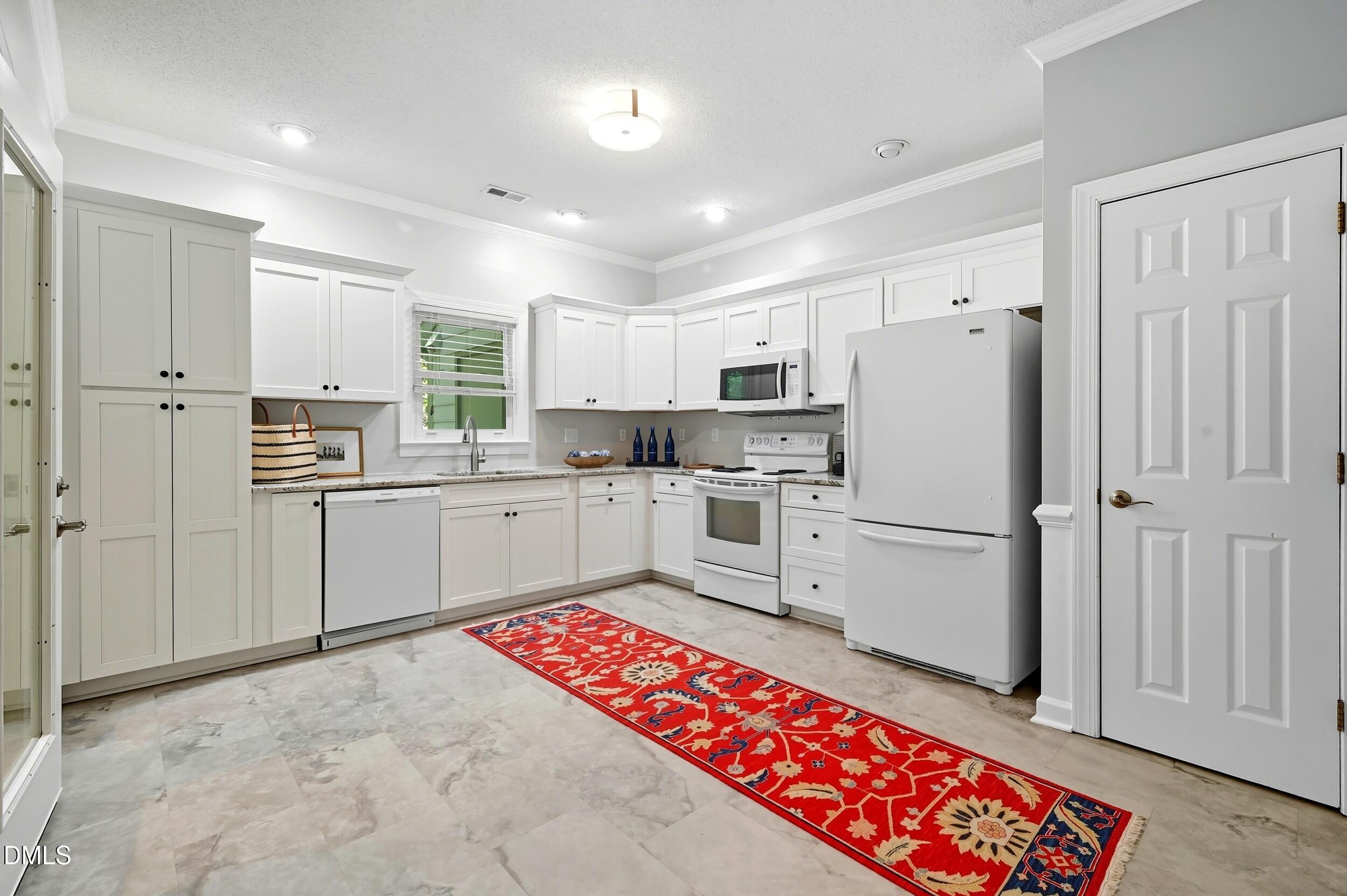 4111 Settlement Drive Durham, NC 27713 - Photo 7 of 25 a kitchen with stainless steel appliances granite countertop a refrigerator sink and cabinets