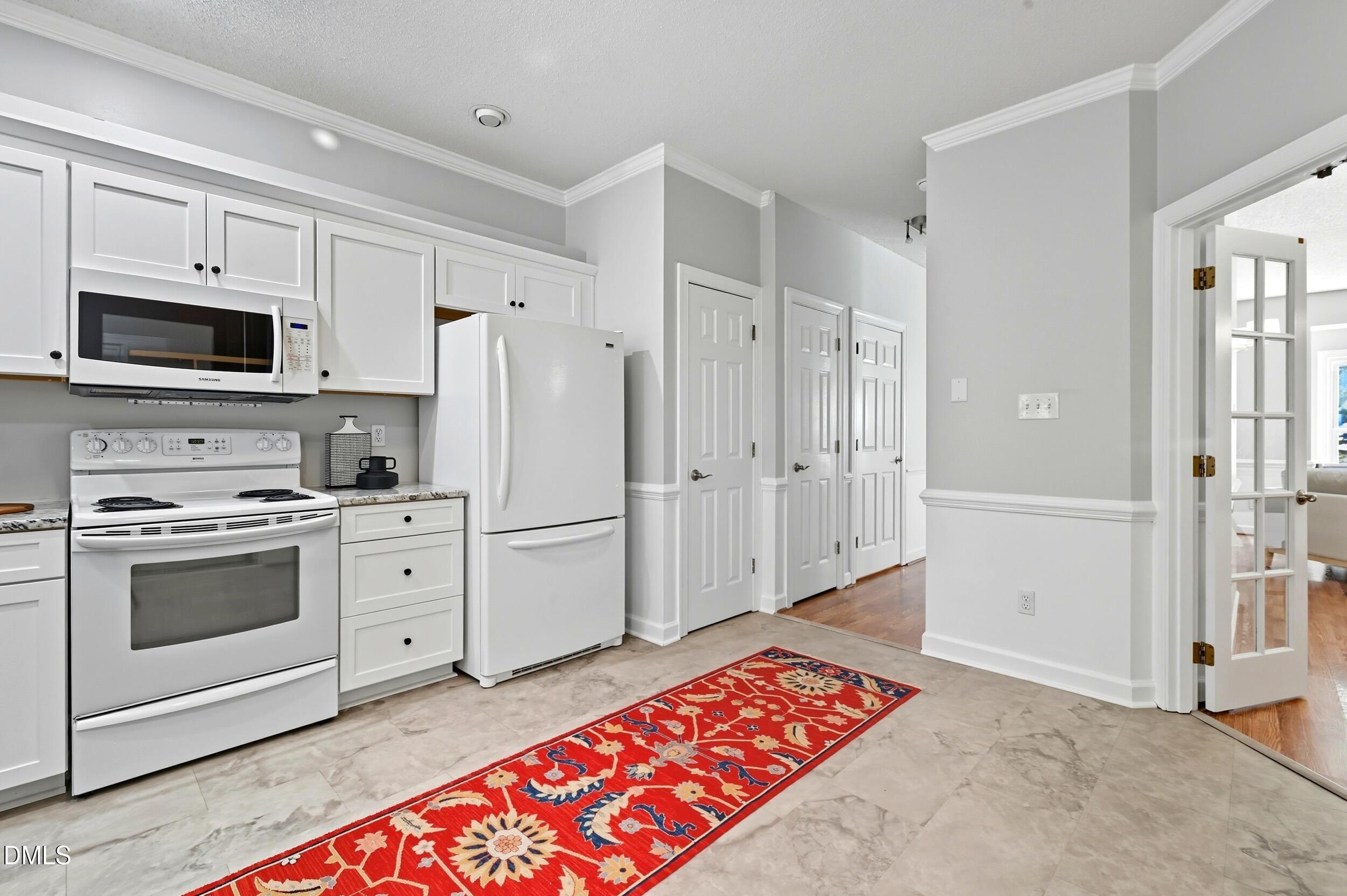 4111 Settlement Drive Durham, NC 27713 - Photo 8 of 25 a kitchen with granite countertop a refrigerator stove and sink