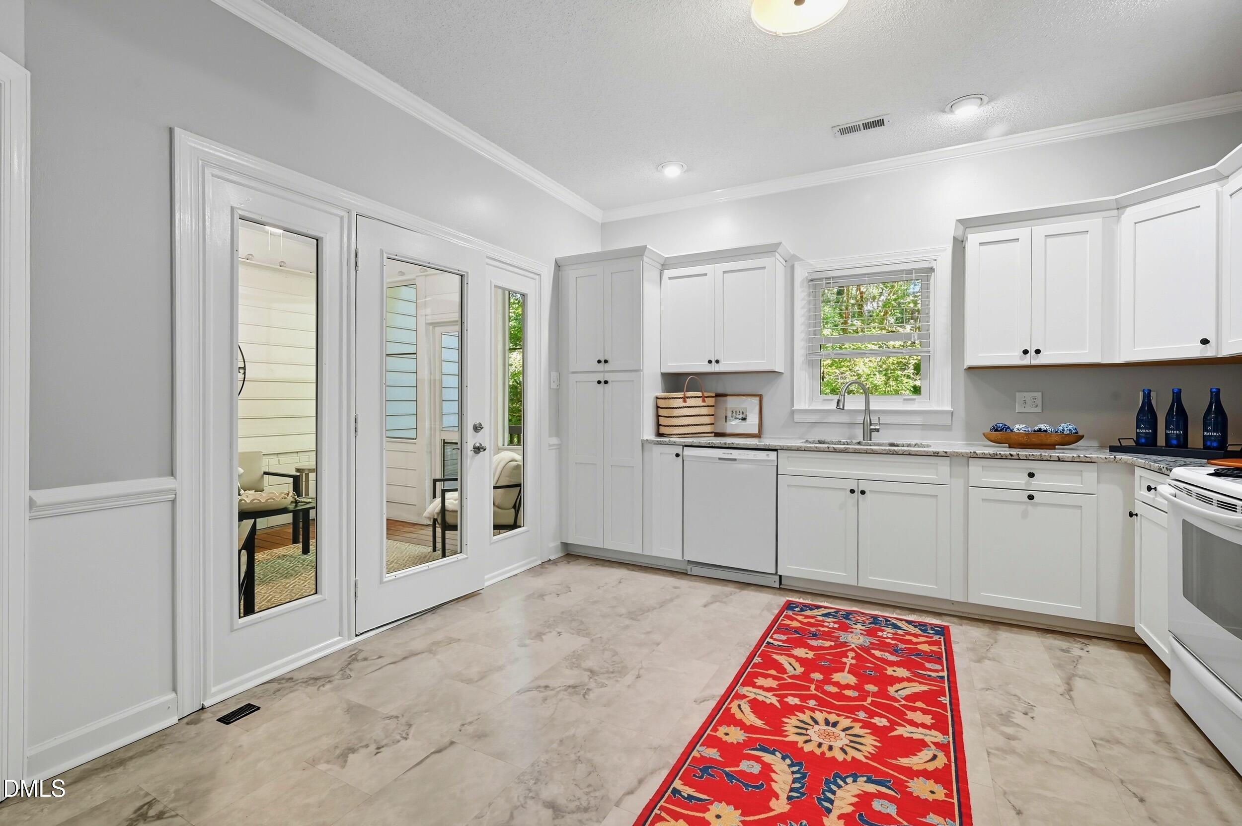 4111 Settlement Drive Durham, NC 27713 - Photo 9 of 25 a kitchen with stainless steel appliances granite countertop a refrigerator sink and window
