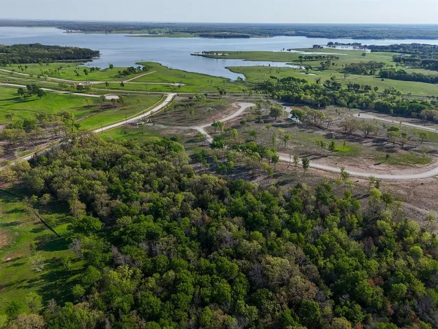 a view of a field with a building in the background