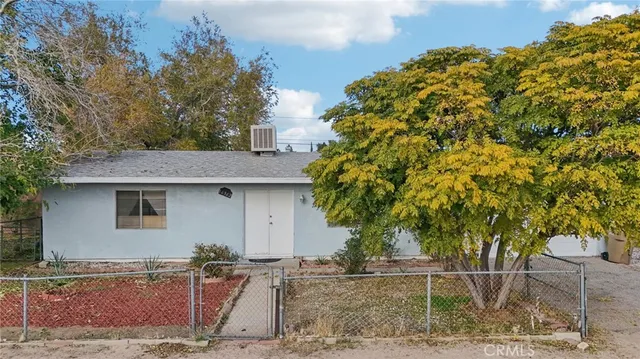a backyard of a house with plants and trees