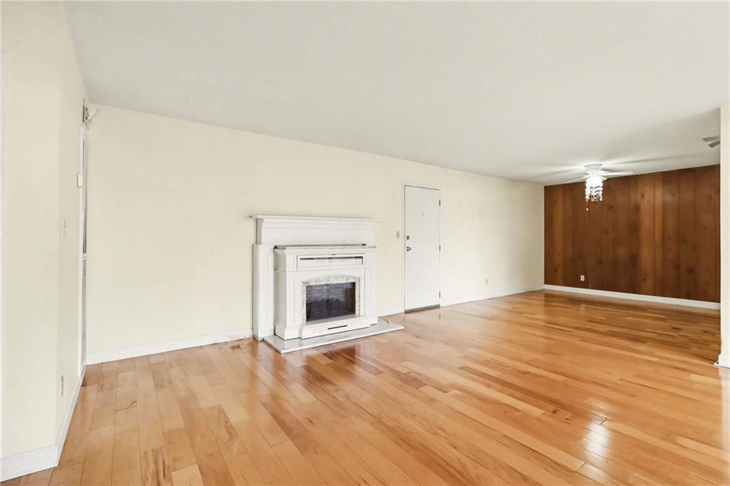4300 Roswell Road Northeast, Unit 4303 Atlanta, GA 30342 - Photo 12 of 39 a view of empty room with wooden floor and fireplace