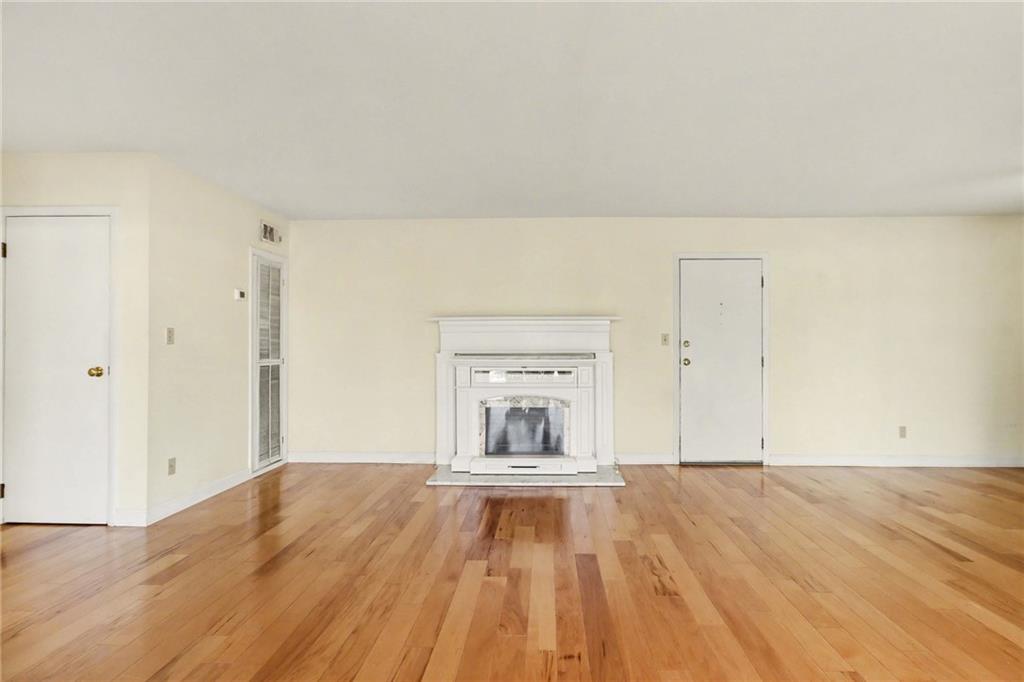 4300 Roswell Road Northeast, Unit 4303 Atlanta, GA 30342 - Photo 14 of 39 a view of empty room with wooden floor and fan