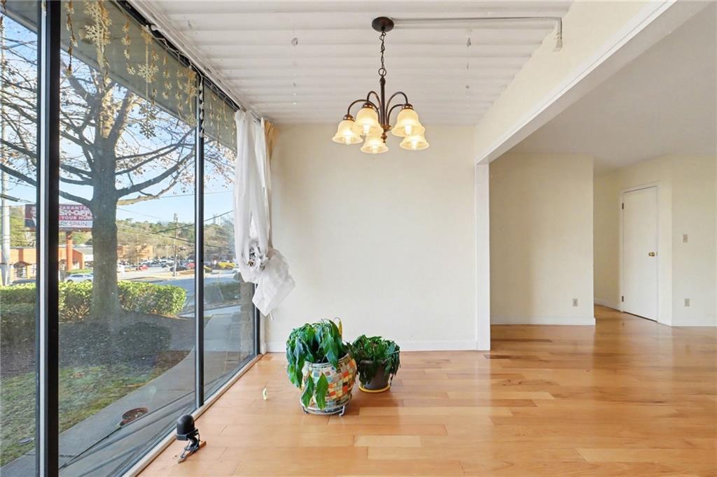 4300 Roswell Road Northeast, Unit 4303 Atlanta, GA 30342 - Photo 17 of 39 a view of a room with a chandelier and wooden floor