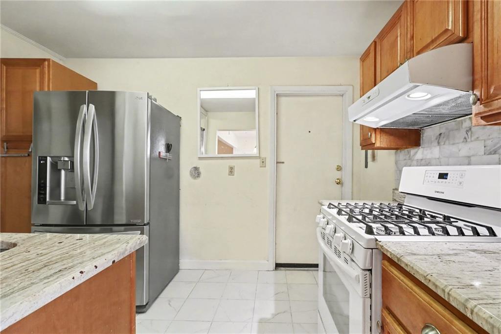 4300 Roswell Road Northeast, Unit 4303 Atlanta, GA 30342 - Photo 20 of 39 a kitchen with stainless steel appliances granite countertop a sink stove and refrigerator