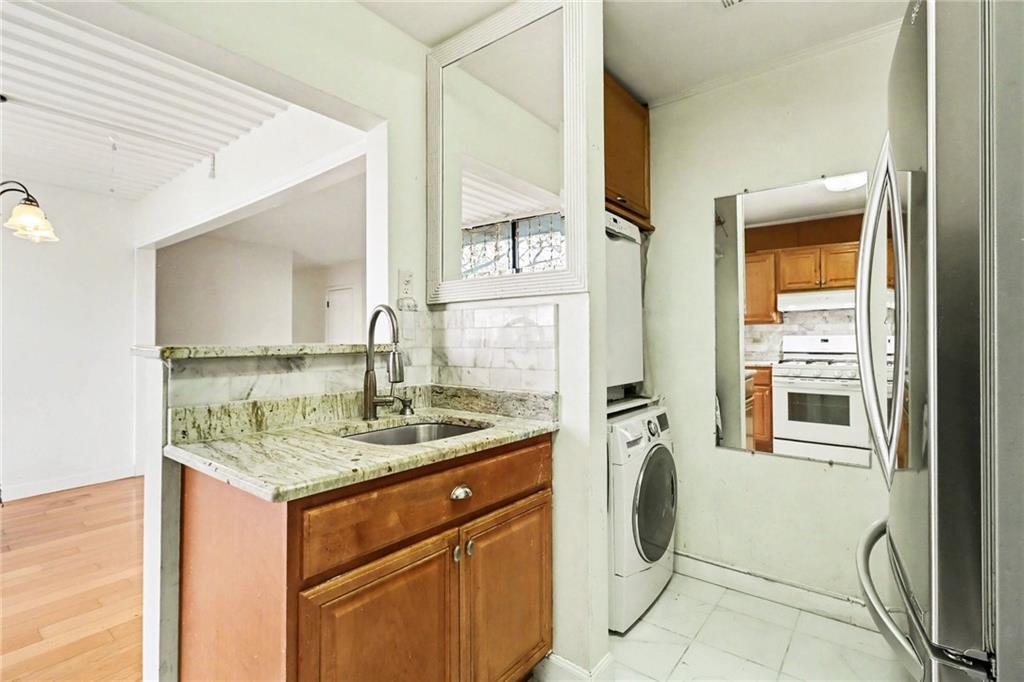 4300 Roswell Road Northeast, Unit 4303 Atlanta, GA 30342 - Photo 21 of 39 a bathroom with a granite countertop sink and a mirror