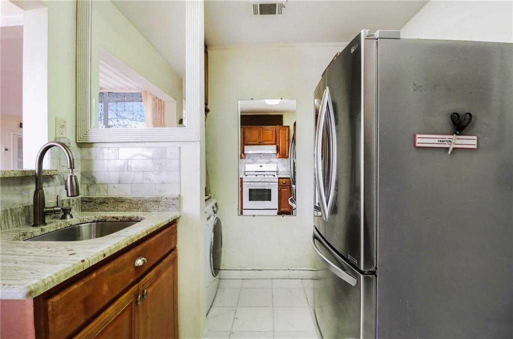 4300 Roswell Road Northeast, Unit 4303 Atlanta, GA 30342 - Photo 22 of 39 a kitchen with a refrigerator and a sink