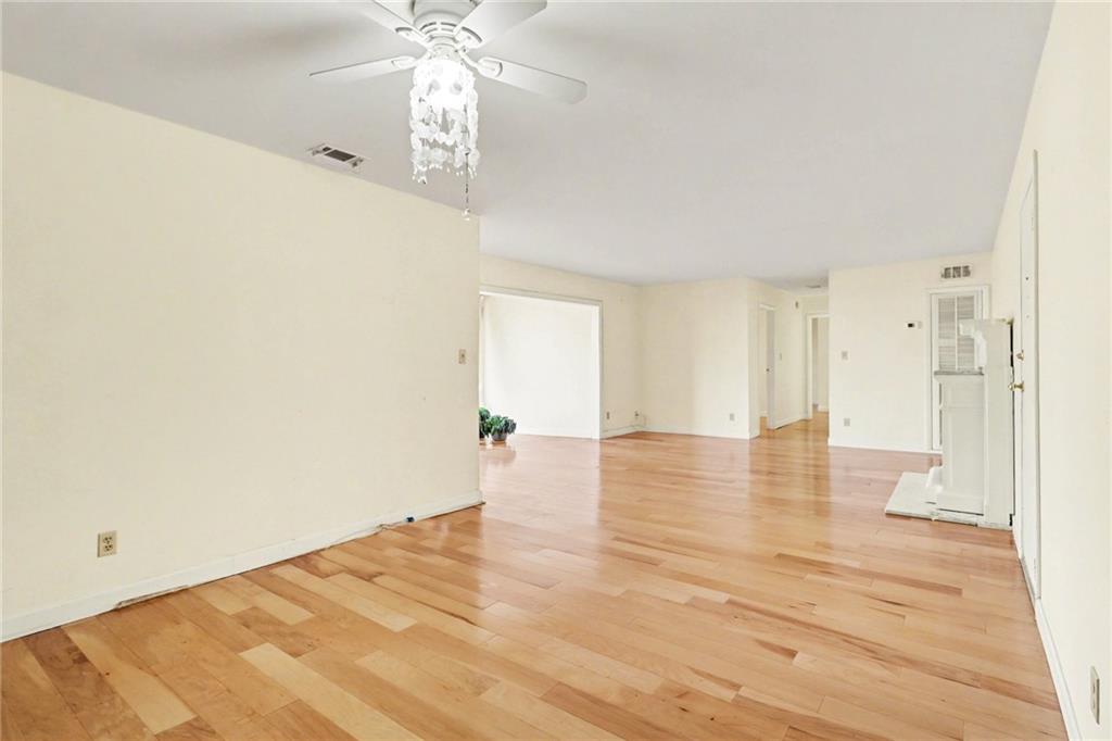 4300 Roswell Road Northeast, Unit 4303 Atlanta, GA 30342 - Photo 25 of 39 a view of an empty room with wooden floor and a window