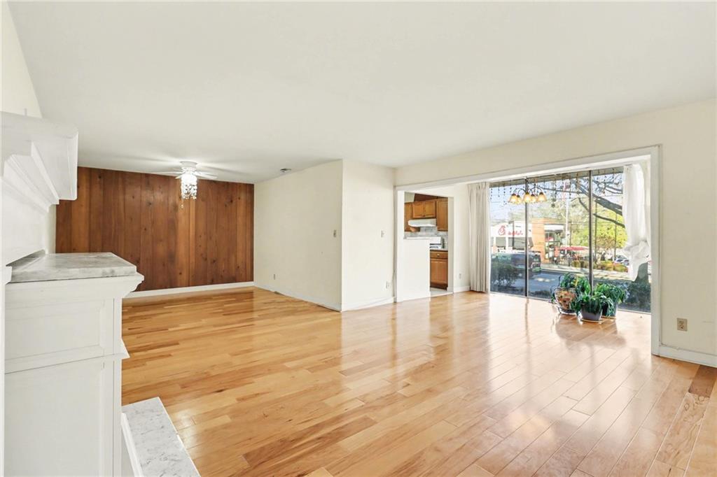 4300 Roswell Road Northeast, Unit 4303 Atlanta, GA 30342 - Photo 26 of 39 a view of empty room with wooden floor and floor to ceiling window