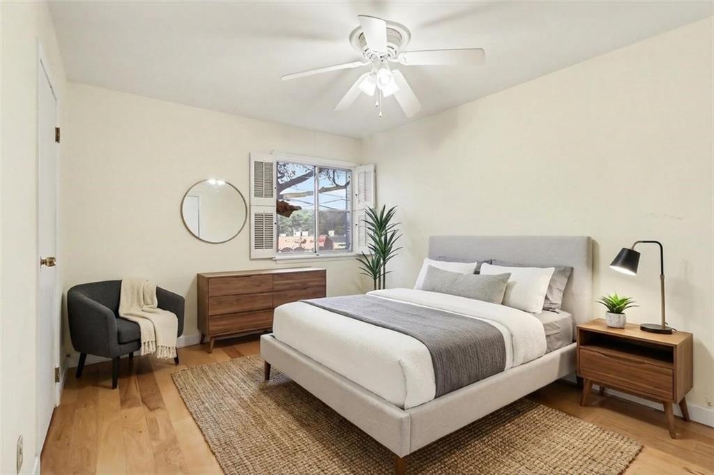 4300 Roswell Road Northeast, Unit 4303 Atlanta, GA 30342 - Photo 27 of 39 a bedroom with a bed a mirror and chair
