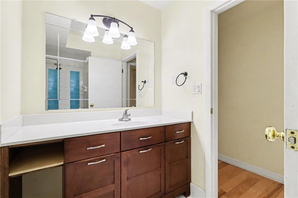 4300 Roswell Road Northeast, Unit 4303 Atlanta, GA 30342 - Photo 30 of 39 a bathroom with a granite countertop sink a mirror and a vanity