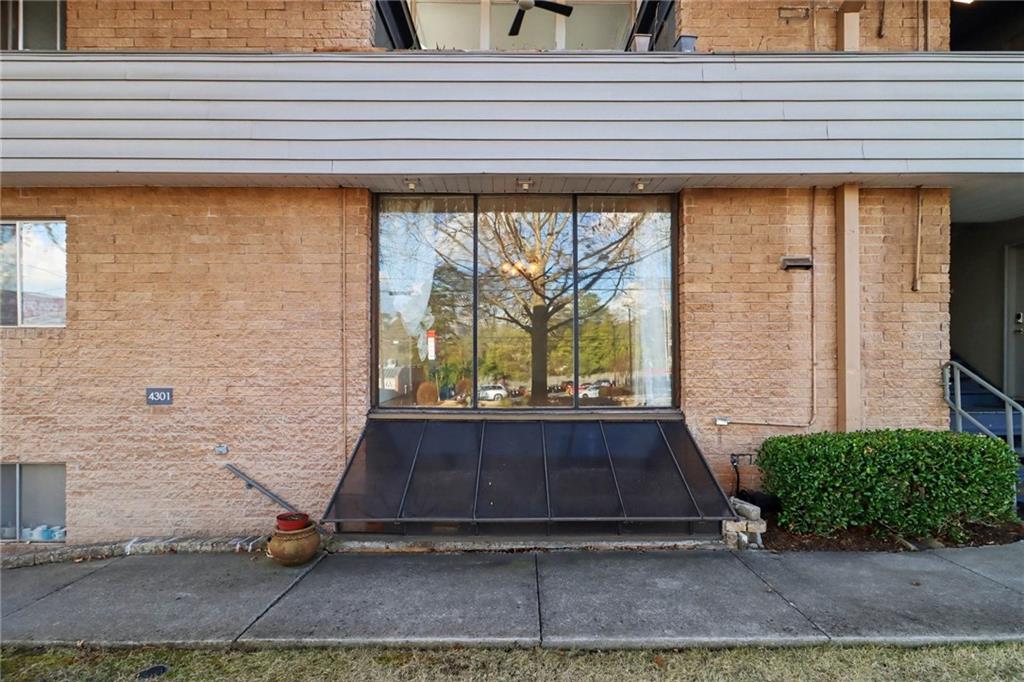 4300 Roswell Road Northeast, Unit 4303 Atlanta, GA 30342 - Photo 3 of 39 a front view of a house with garden