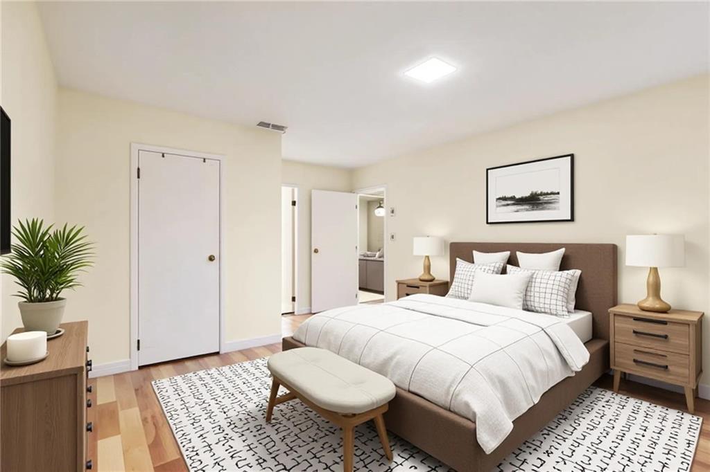 4300 Roswell Road Northeast, Unit 4303 Atlanta, GA 30342 - Photo 34 of 39 a spacious bedroom with a bed and a couch