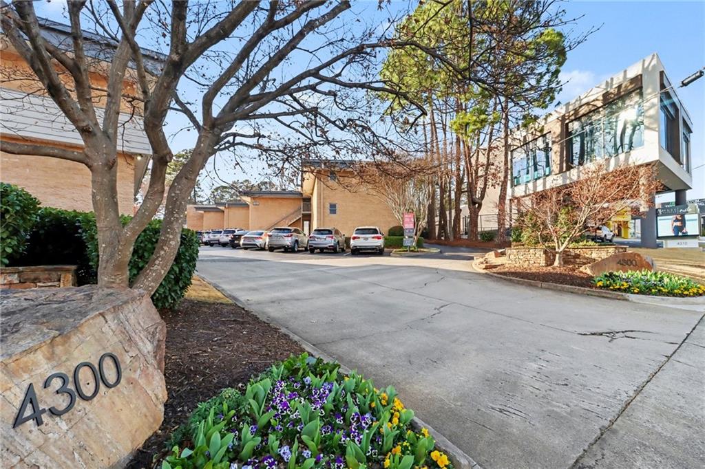4300 Roswell Road Northeast, Unit 4303 Atlanta, GA 30342 - Photo 37 of 39 a view of a street with a building and trees in the background