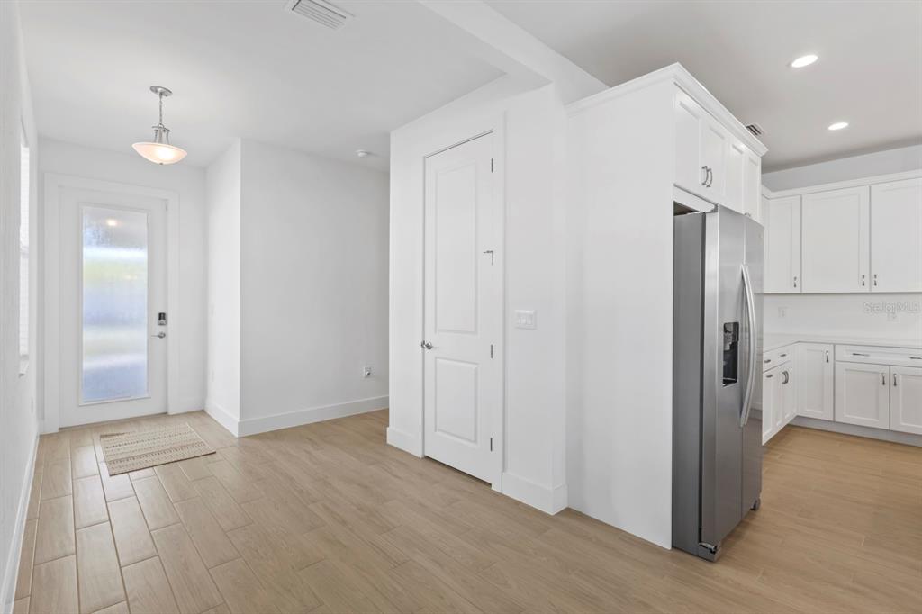 44319 Panther Drive Punta Gorda, FL 33982 - Photo 11 of 49 a view of a kitchen with a refrigerator and wooden floor