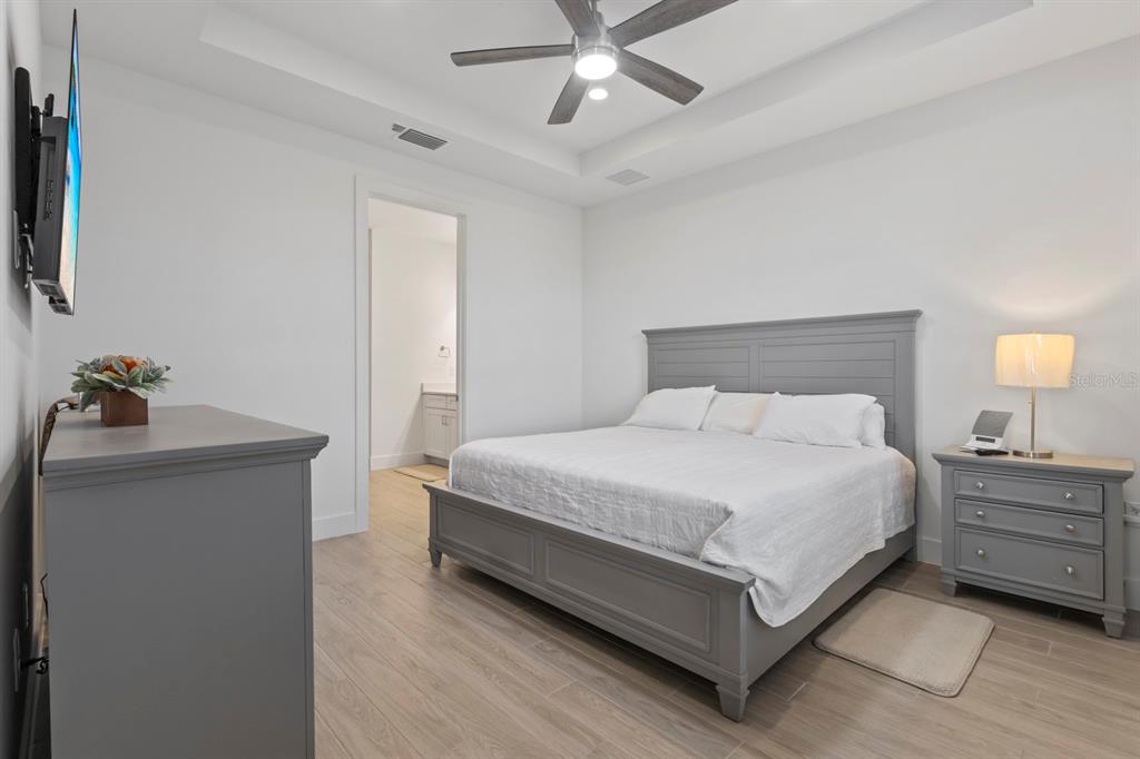 44319 Panther Drive Punta Gorda, FL 33982 - Photo 22 of 49 a bedroom with a bed and a potted plant