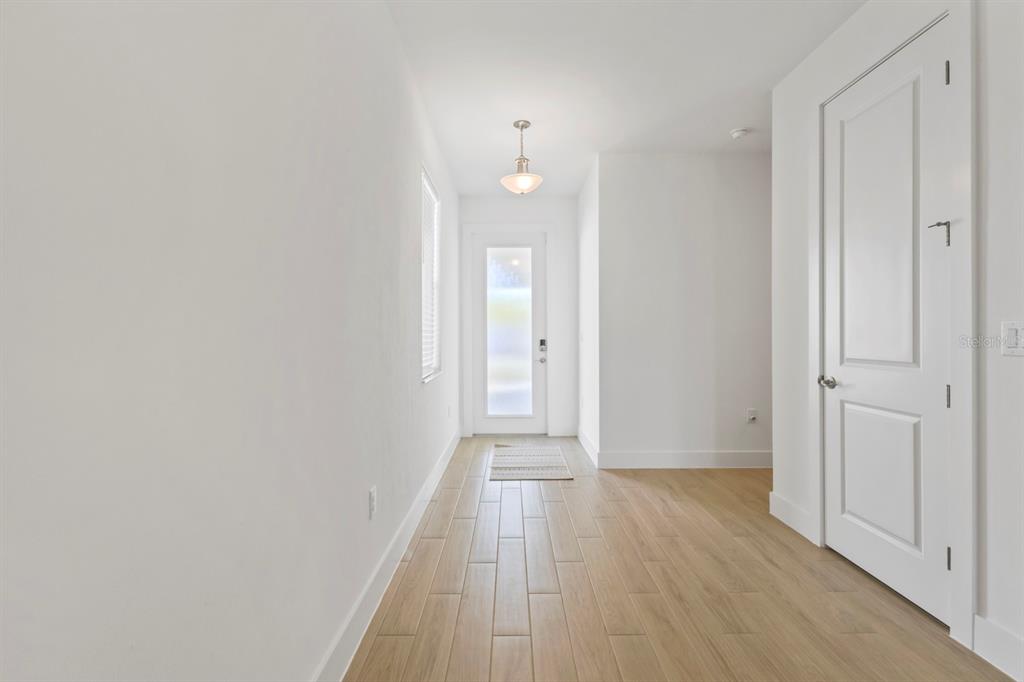44319 Panther Drive Punta Gorda, FL 33982 - Photo 25 of 49 a view of a hallway with wooden floor