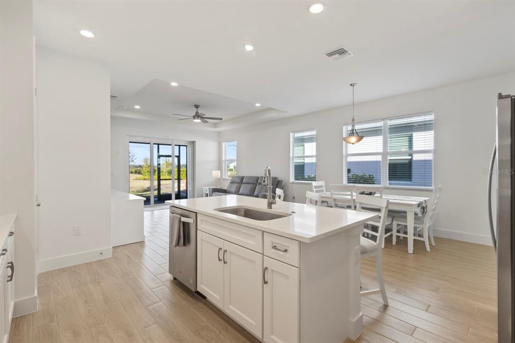 44319 Panther Drive Punta Gorda, FL 33982 - Photo 6 of 49 an open kitchen with a sink and breakfast area