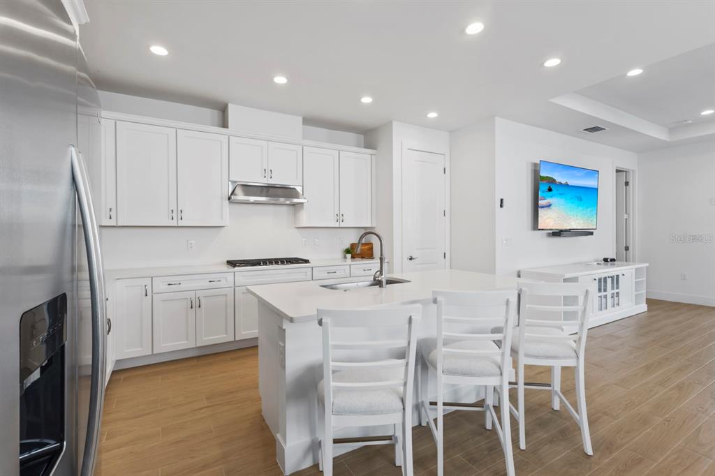 44319 Panther Drive Punta Gorda, FL 33982 - Photo 8 of 49 a kitchen with white cabinets and chairs