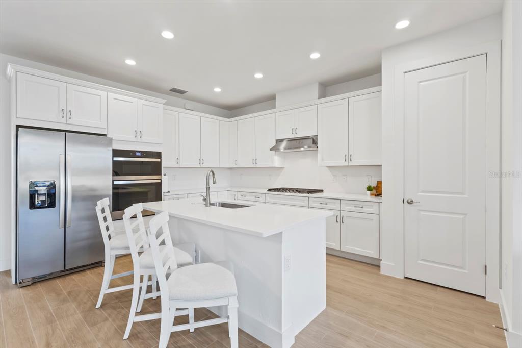 44319 Panther Drive Punta Gorda, FL 33982 - Photo 9 of 49 a kitchen with a refrigerator and white cabinets