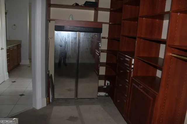 a kitchen with stainless steel appliances granite countertop a sink window and cabinets