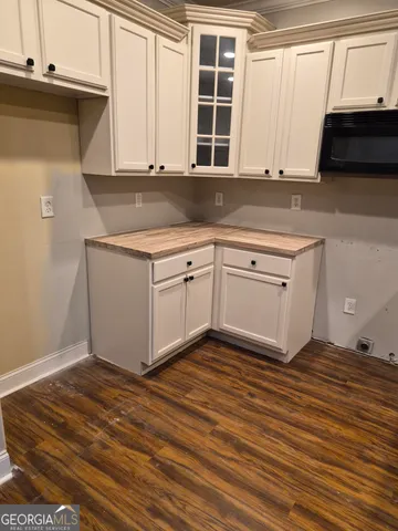 an empty room with wooden floor windows and wooden floor
