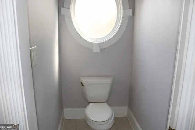 a white toilet sitting next to a small sink