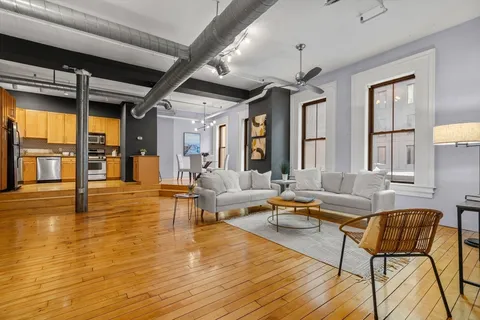 a living room with fireplace furniture and a wooden floor
